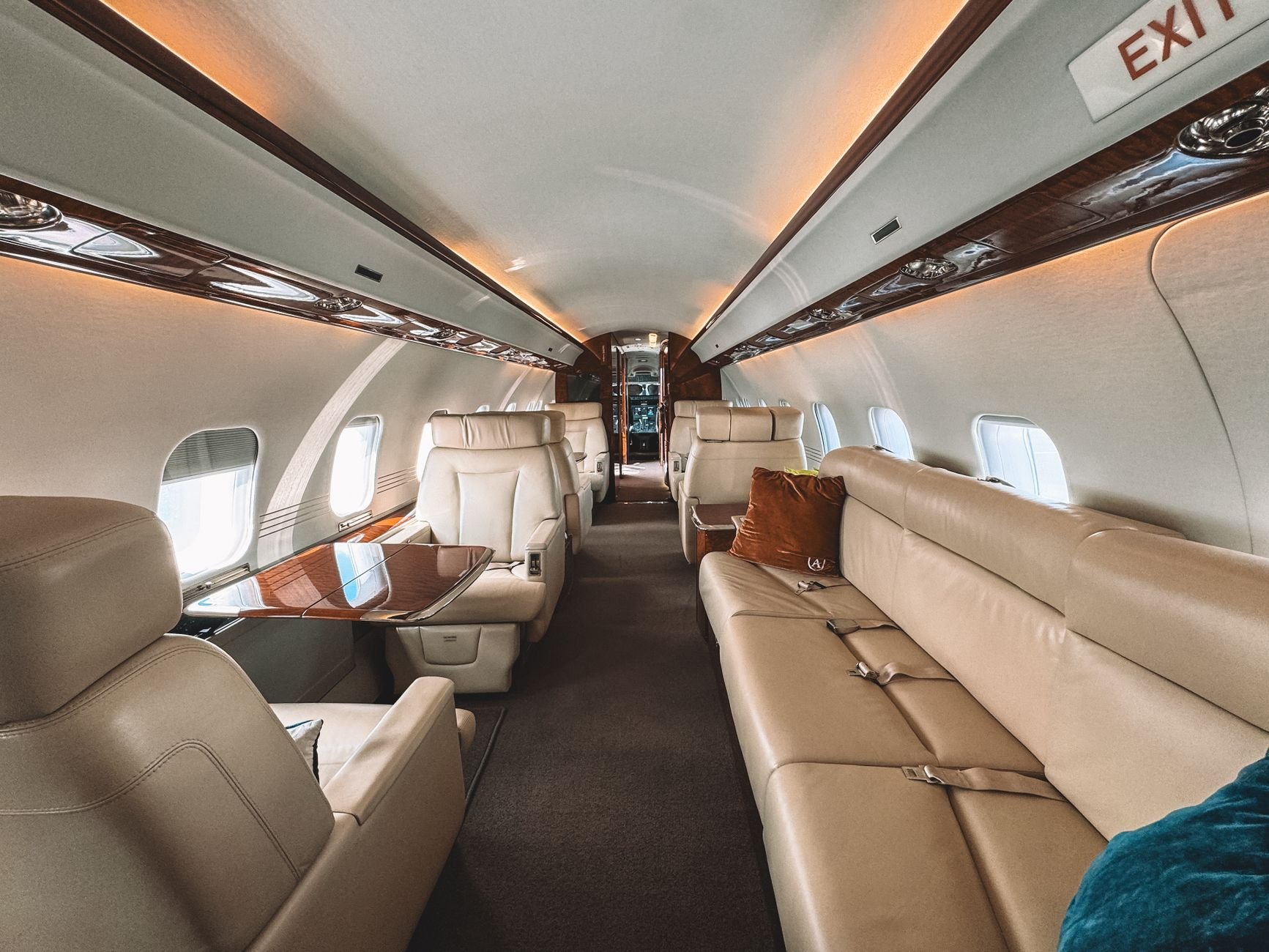 Luxury private jet interior with leather seats and warm wood trim